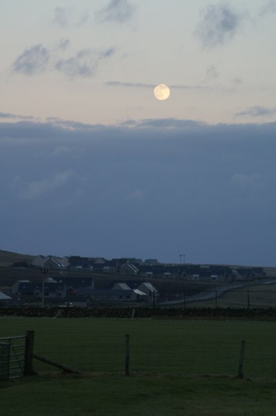 full moon over houses